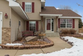 Concrete drive, walkway, and welcoming landscaping