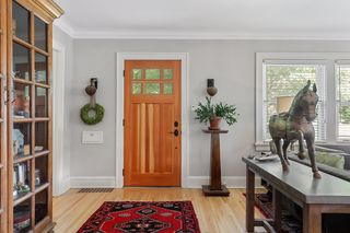 Front Door entry into open Living Room with wood burning fireplace