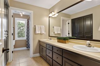 Upstairs bath with 2 sinks and a separate toilet and shower area