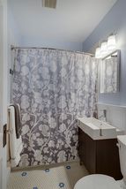 Updated main bath - tile, sink, toilet and wainscot. 