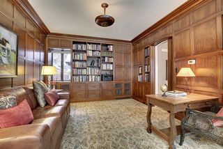 The Library features Wood Paneled Walls, Original Bronze Light Fixture and incredible Stained Glass Windows...
