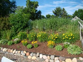 Natural grasses, lakeside landscaping buffer the slope.