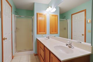 Showing double vanity with medicine cabinet and shower.