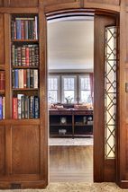 The Pocket Doors that leads the Main Floor Library is Hand Crafted Stained Glass..