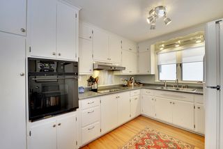 The Kitchen features a Wall Oven, Cooktop & Hardwood Floors...