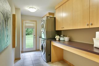 Main floor laundryroom has lots of counterspace and another door to the back yard.
