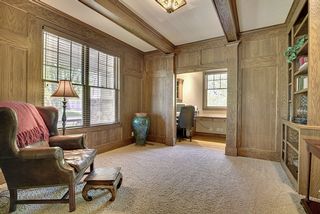 Warm, spacious, bookcases, builtins and floor to ceiling custom panels - beamed ceiling