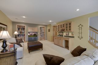 Lower level boasts of lots of storage space behind the bookshelves and behind the bedroom...