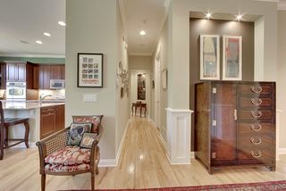 The hallway to the master bedroom features an additional art niche with canned lighting.