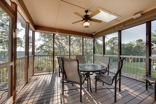 This porch features sound, drop down custom shades, a skylight and floor to ceiling screening 