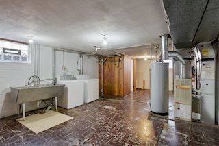 Laundry Room has washer/dryer and utilities, along with a half bath