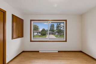 Main-level bedroom with refinished hardwood floors and abundant natural light