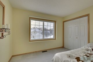 Warm and inviting second bedroom or office with an oversized closet
