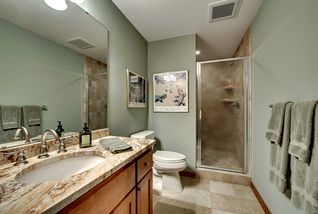 Lower Guest/Hall bath with granite top, integral bowl sink. Large tiled - walk - in shower.