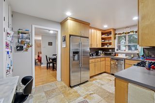 Updated kitchen features Stainless Steel appliances and Custom Maple cabinets, Travertine Tile flooring and a built-in pantry.