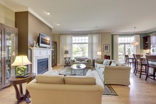 The living room features large picture windows with high end window treatments.