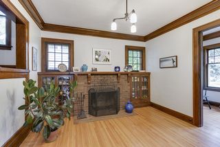 Classic brick fireplace flanked by glass-doored built-in bookshelves