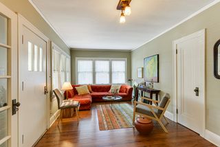 Light and bright living room with walls of windows and hardwoond floors.