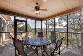 The space features composite decking, aluminum railings and natural cedar posts.