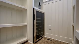 Wine cooler and built-in wine rack in the spacious pantry!