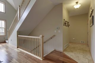 Central staircase, tiled back entry to garage. 