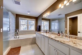 Fantastic bath space with a soaking tub, glass block shower, dual vanity with granite tops, brushed nickel plumbing fixtures.