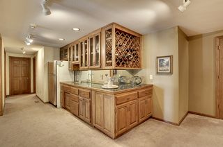 Bar area has a marble top, polished sink and full size refrigerator!