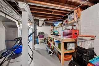 Another view of additional room for storage or flex space in basement. Built in shelving .
