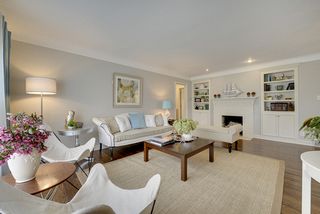 Living room with brick, wood burning fireplace and built-ins. 