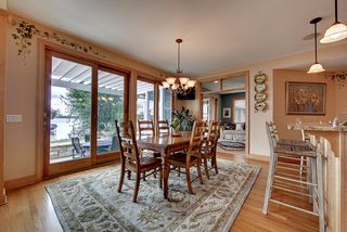 Kitchen dining area with large sliding Andersen door units to patio and Bald Eagle Lake.