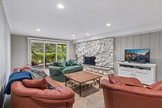 Spacious lower level family room with wood burning fireplace