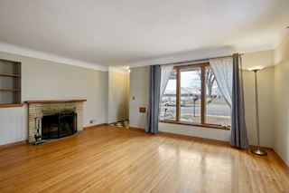 Main Floor Living Room with great light, hardwood floors and a woodburning fireplace