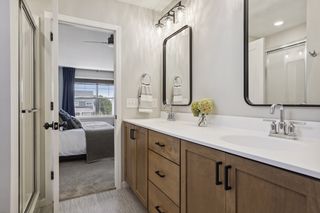 A beautiful well-appointed bathroom with dual sinks, mirrors and cabinetry 
is enjoyed by the homeowners.