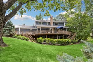 Outdoor deck and lower level patio look out on the private backyard