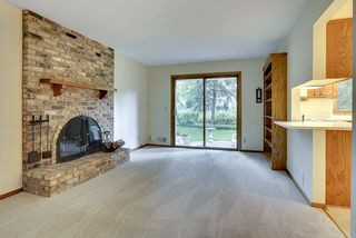 Hearth room, brick wood fireplace & sliders out to patio. 