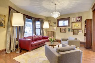 The Living Room features an Original Bay Window, Hardwood Floors & Crystal Chandelier! 