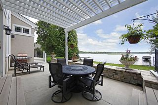 Protected raised patio area with trellised canopy for sun protection.