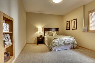 Bedroom with bookshelf that opens up to storage area