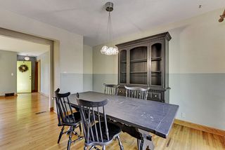 The Dining Room features Hardwood Floors, Glass Pendant Light & Patio Doors to the Back Deck...