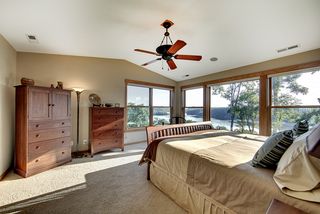 Vaulted ceiling with a decorative fan, Large Marvin windows capture the sweeping long views to the North and East.