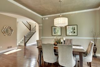 Stunning formal dining room with faux painted ceiling, crown molding, chair rail and hardwood floors