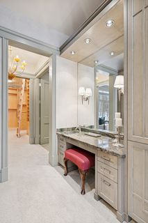 Dressing area with a full length triple mirror and make-up area.