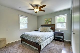 Master bedroom with newer ceiling fan and refinished floors