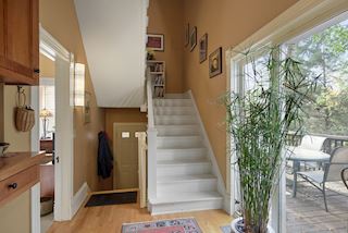 Back door with stairway from main level to second floor back unit and sliding door entry onto one of three decks 