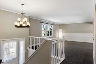 Split-level entry to a beautifully renovated open floor plan main level with living room, dining room and kitchen