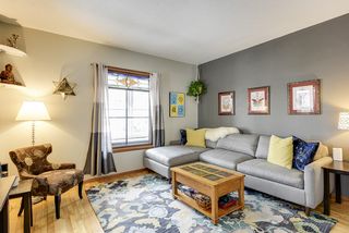 Living room with refinished hardwood floors, classic colors and stained glass window