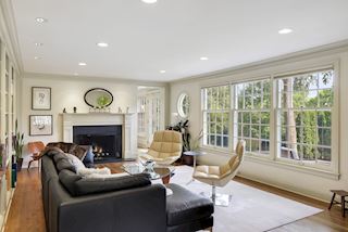 Beautiful home awash with sunshine and light with walls of windows to experience the lush landscaping from inside