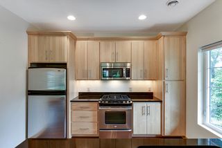 Kitchen offers beautifully finished cabinets and counterheight seating for your guests.