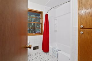 The Upper Level Full Bath features a window with private views 
and a Linen Closet.