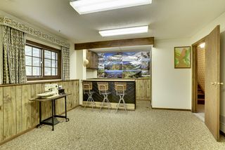 Lower level entertainment room with lookout windows and wet bar. Perfect space for a pool table, ping pong or foosball!